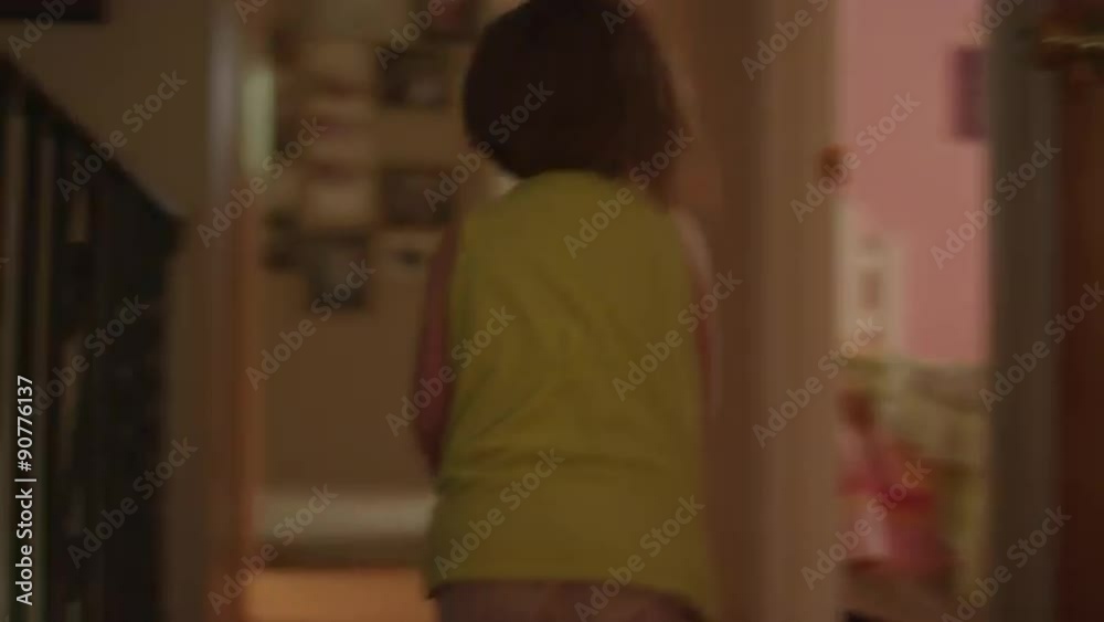 A little girl riding her toy horse through the halls of her house
A little girl riding her toy horse through the halls of her house