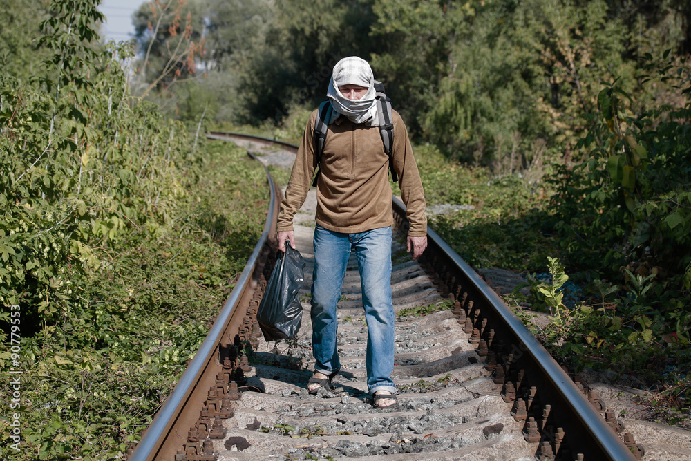 Man acting as a refugee on a railway Man acting as a refugee on a railway