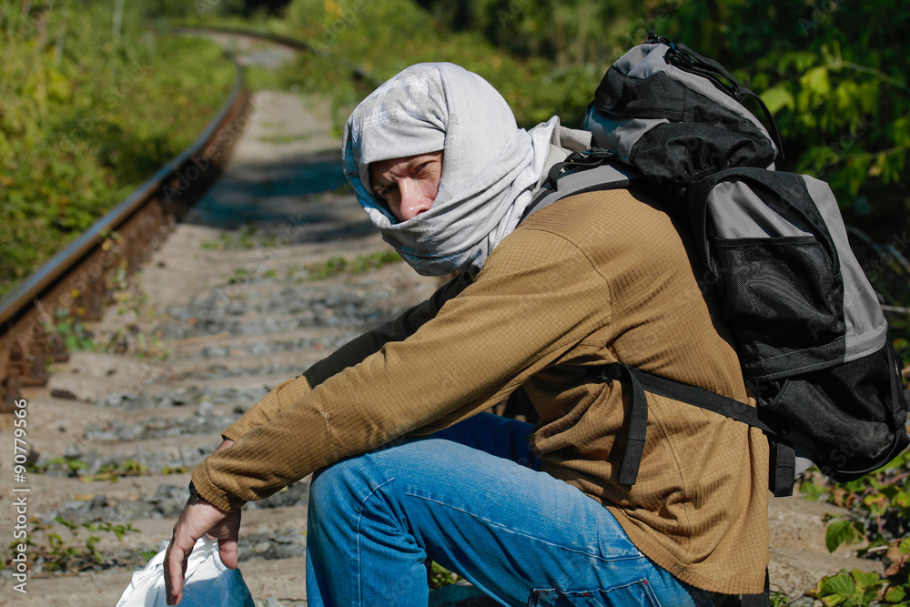 Man acting as a refugee on a railway Man acting as a refugee on a railway