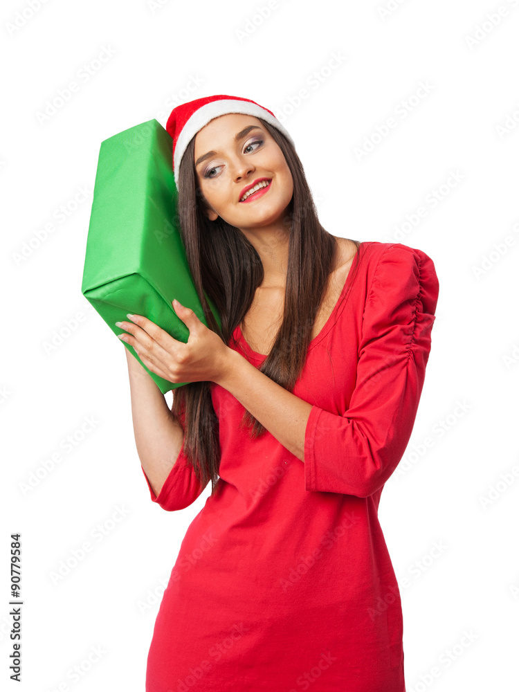 Surprised girl in a Christmas costume is holding a green gift Surprised girl in a Christmas costume is holding a green gift
