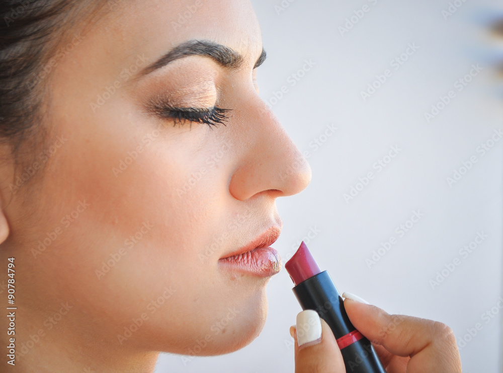 woman applying lip stick, makeup