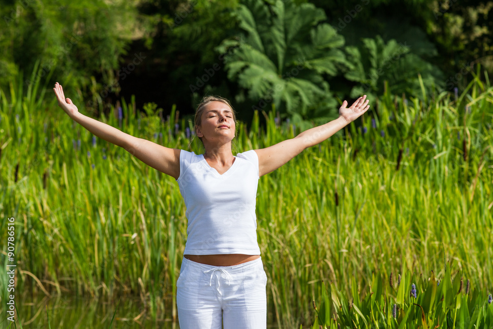 outdoors meditation - gorgeous young yoga woman outstretching arms,closing eyes to focus on inner beauty to relax and meditate with green bushy background and summer daylight outdoors meditation - gorgeous young yoga woman outstretching arms,closing eyes to focus on inner beauty to relax and meditate with green bushy background and summer daylight