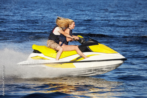 Couple riding jet ski