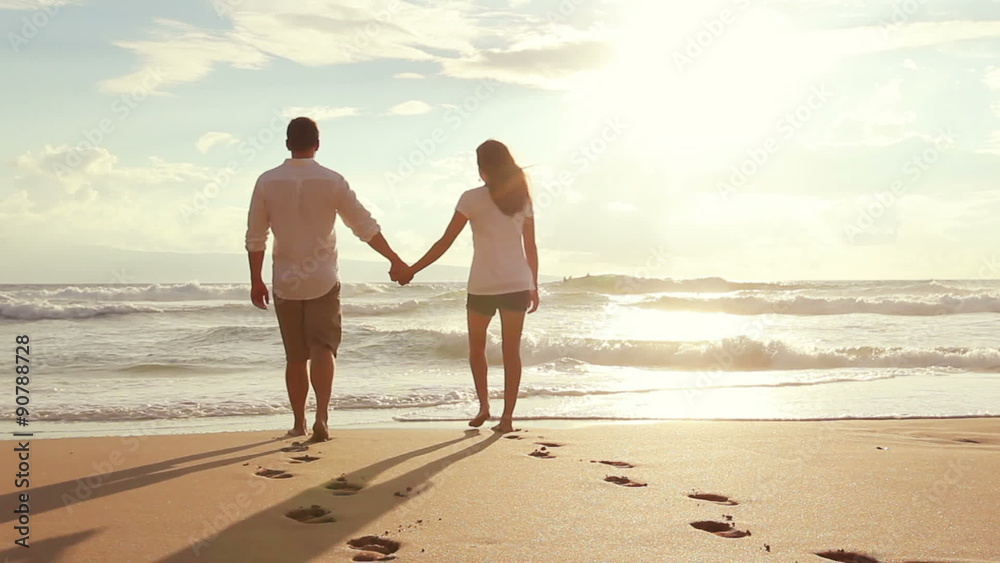 Attractive Young Brunette couple holding each other. romantic in love kissing at beach sunset. Newlywed happy young couple enjoying ocean sunset during travel holidays vacation getaway. Attractive Young Brunette couple holding each other. romantic in love kissing at beach sunset. Newlywed happy young couple enjoying ocean sunset during travel holidays vacation getaway.