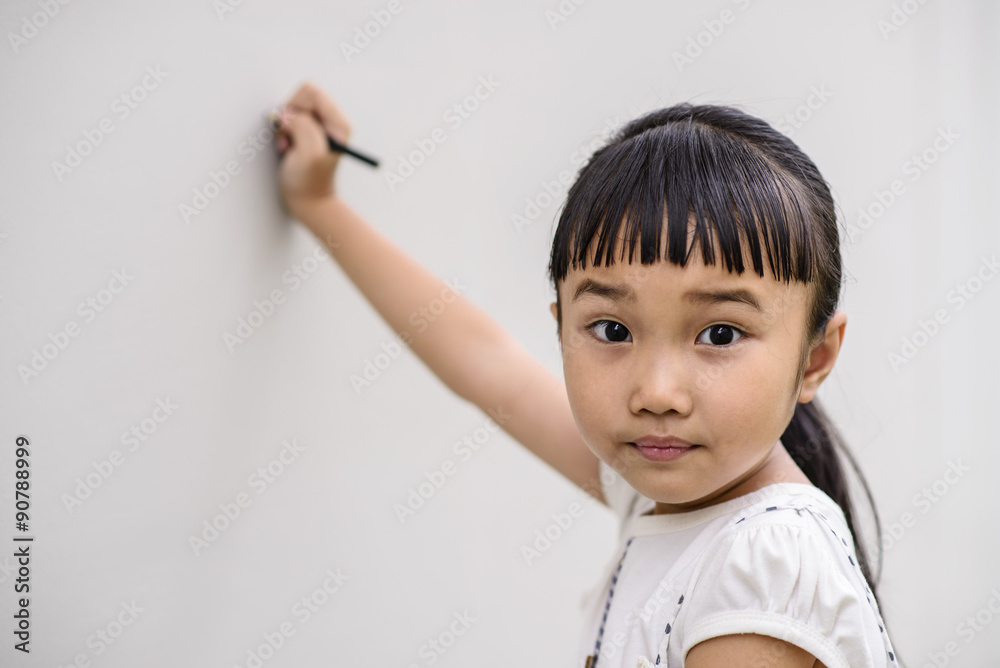 Kid with surprise pose and writing on wall Kid with surprise pose and writing on wall