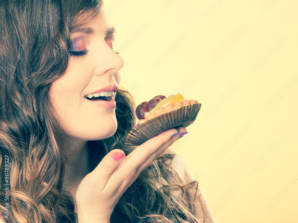 woman closed eyes holds cake in hand woman closed eyes holds cake in hand