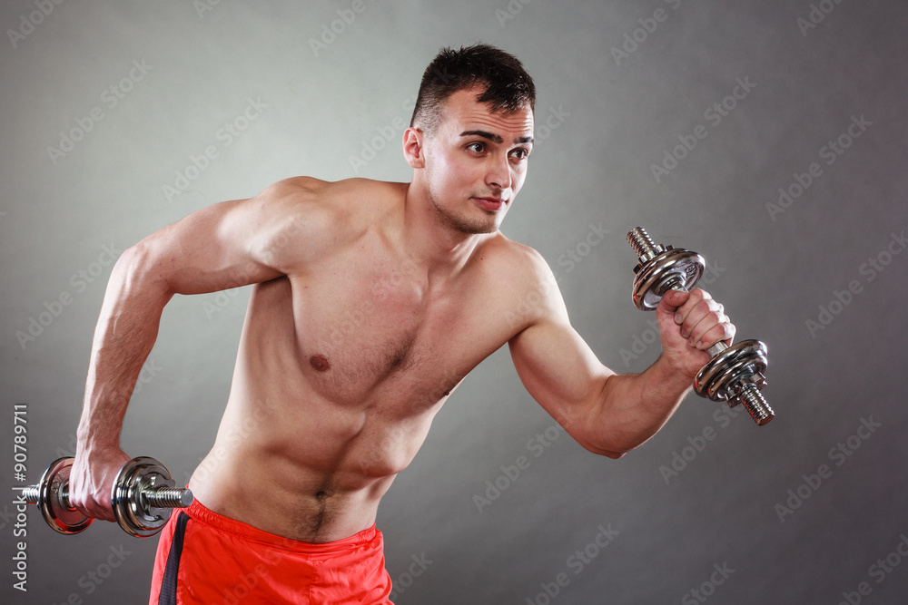 athletic man working with heavy dumbbells