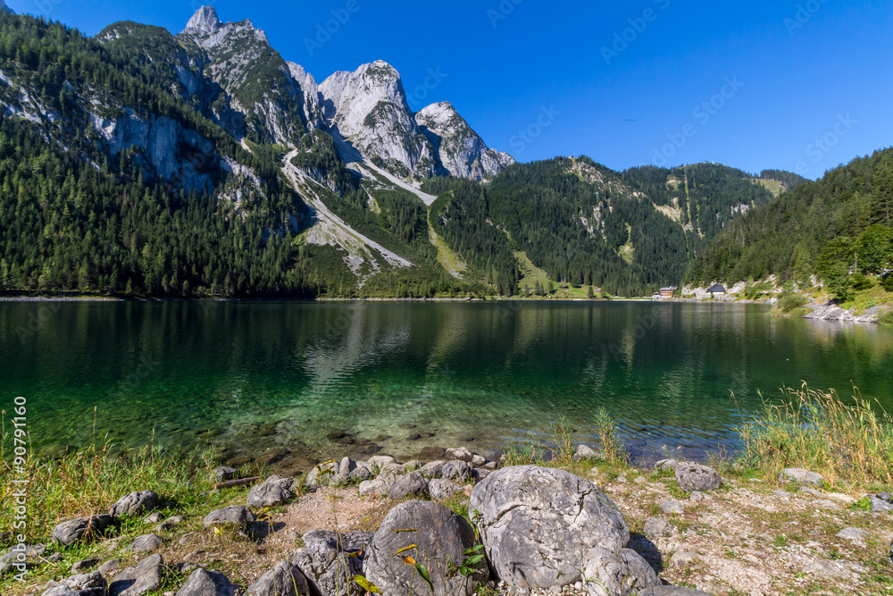 Fototapeta premium Beautiful landscape of alpine lake with crystal clear green water and mountains in background, Gosausee, Austria