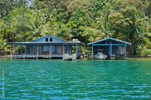 Tropical home and boat house over the sea