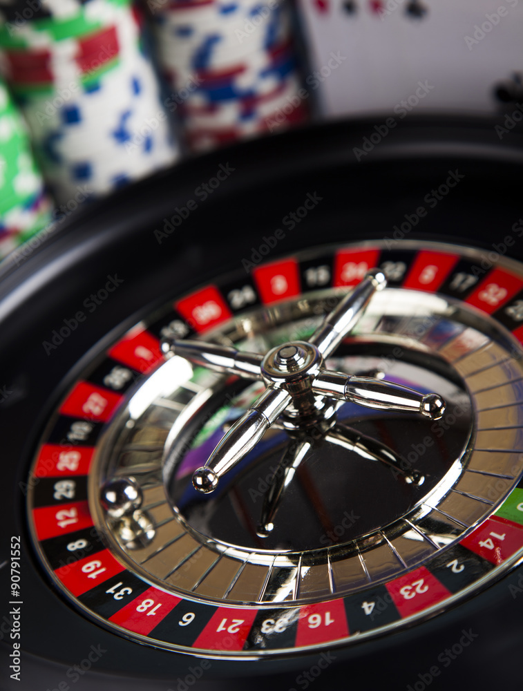 Poker Chips on a gaming with casino roulette Poker Chips on a gaming with casino roulette