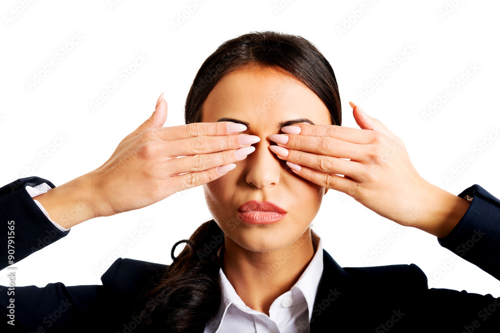 Businesswoman covering eyes with hands Businesswoman covering eyes with hands
