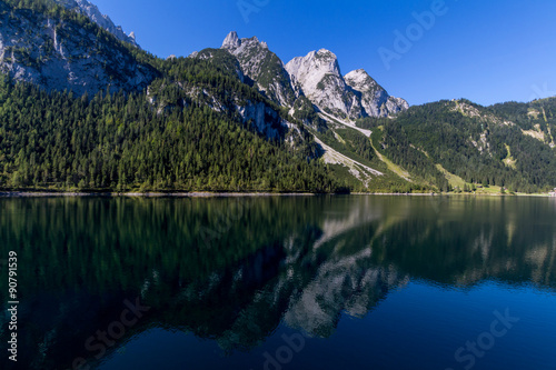 Beautiful landscape of alpine lake with crystal clear green water and mountains in background  Gosausee  Austria