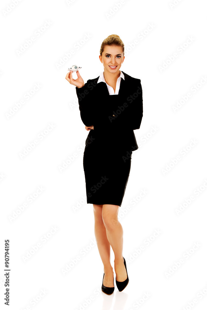 Beautiful businesswoman holding airplane miniature Beautiful businesswoman holding airplane miniature