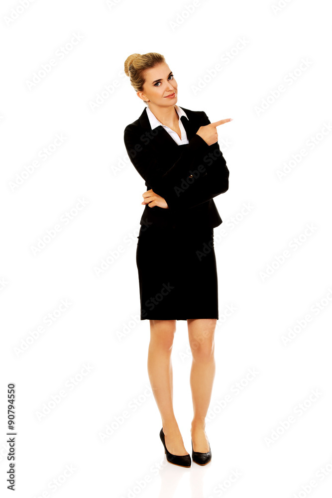 Young smiled businesswoman pointing her finger Young smiled businesswoman pointing her finger