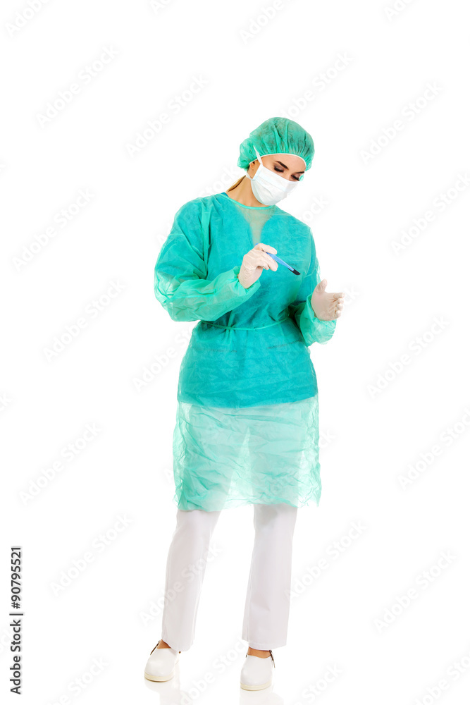 Female surgeon doctor with a scalpel performs the surgery Female surgeon doctor with a scalpel performs the surgery