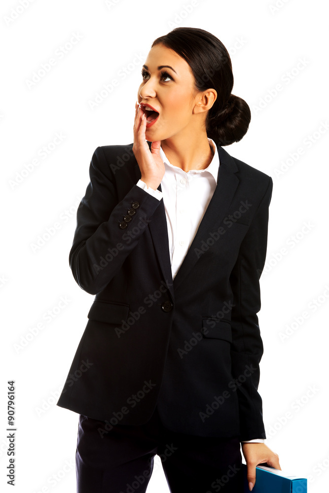 Shocked businesswoman holding a binder Shocked businesswoman holding a binder