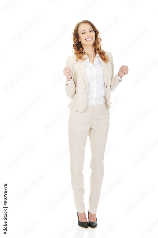 Successful businesswoman making fists. Successful businesswoman making fists.