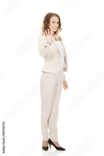 Businesswoman showing hand to camera.