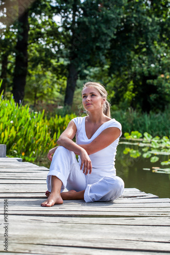 20s blond girl dreaming in the sun relaxing outdoors