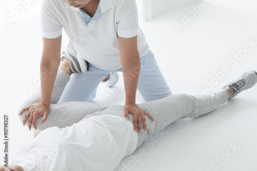 Physical Therapist have stretch a woman's hip