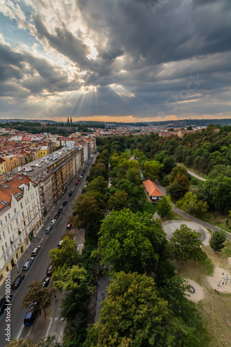 View of Prague taken from Nuselsky bridge on sunset captures typical local architecture from aerial perspective. Famous Vysehrad castle is behind it.