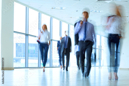businesspeople walking in the corridor of an business center