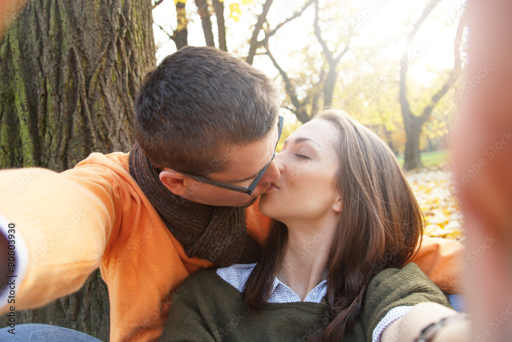 Fototapeta premium Young couple taking selfie in park