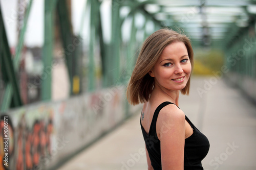 Young beautiful woman smiling on a bridge