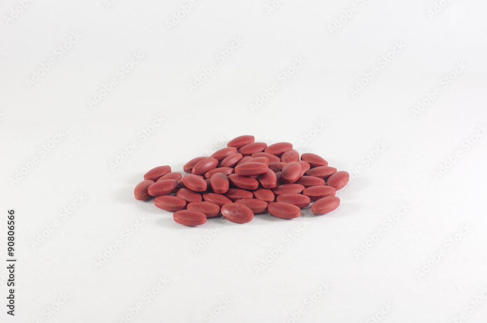 Group of dark red medical pills isolated on white background Group of dark red medical pills isolated on white background