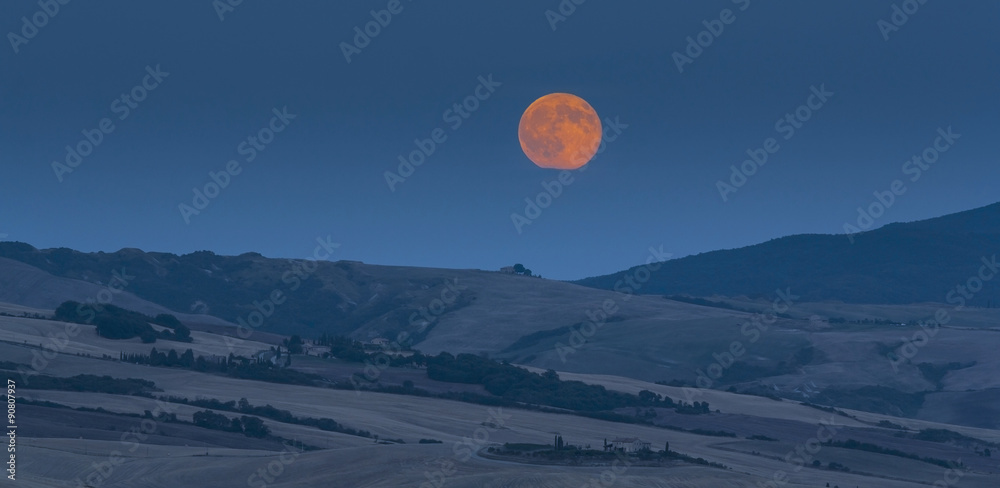 Tuscan landscape. Picturesque countryside villa under full moon
