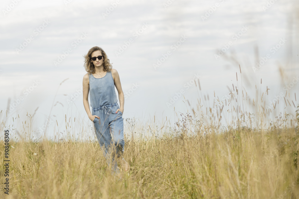 beautiful young woman posing on a meadow. Summer fashion photo. Lifestyle beautiful young woman posing on a meadow. Summer fashion photo. Lifestyle