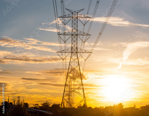 High voltage transmission lines on orange and blue sky, sunrise
