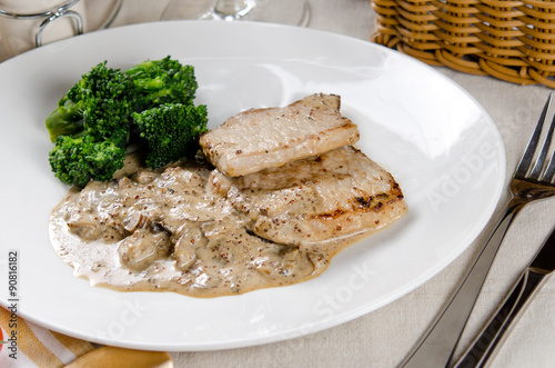 medallions of pork stewed with mushrooms in a creamy garlic sauc
