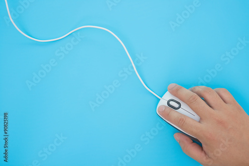 man using a white mouse on a blue background