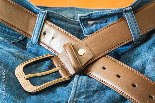 Leather belt on jeans pants background