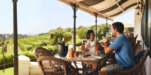 Couple enjoying a glass of wine in a winery restaurant