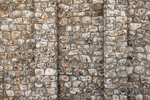 Old wall with many small and big stones