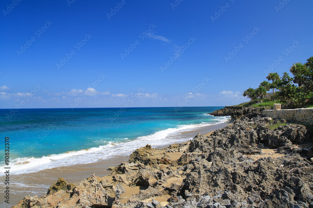 Ocean with waves and rocks on caribbean beach