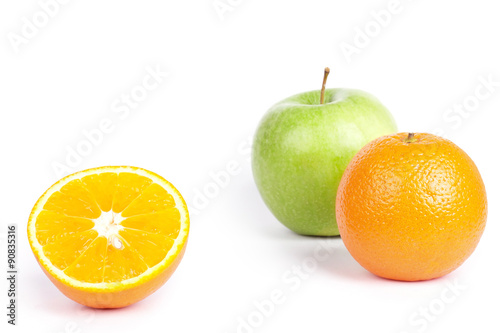 Oranges and green apple on white