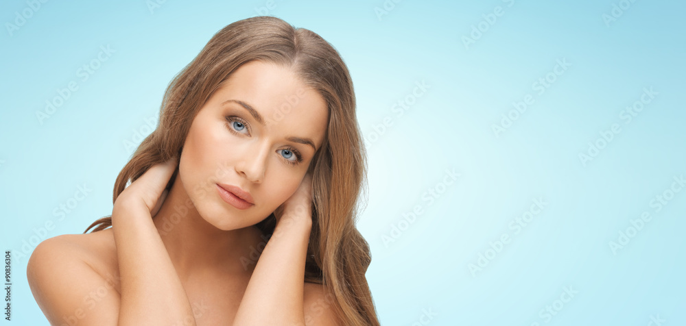 beautiful young woman face over blue background beautiful young woman face over blue background