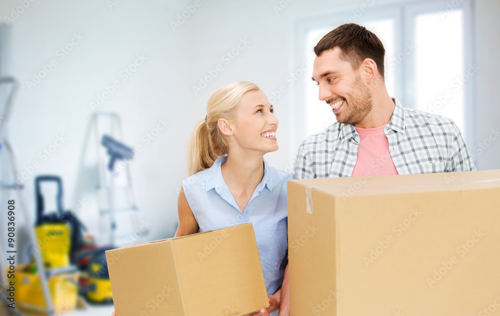 couple with cardboard boxes moving to new home couple with cardboard boxes moving to new home