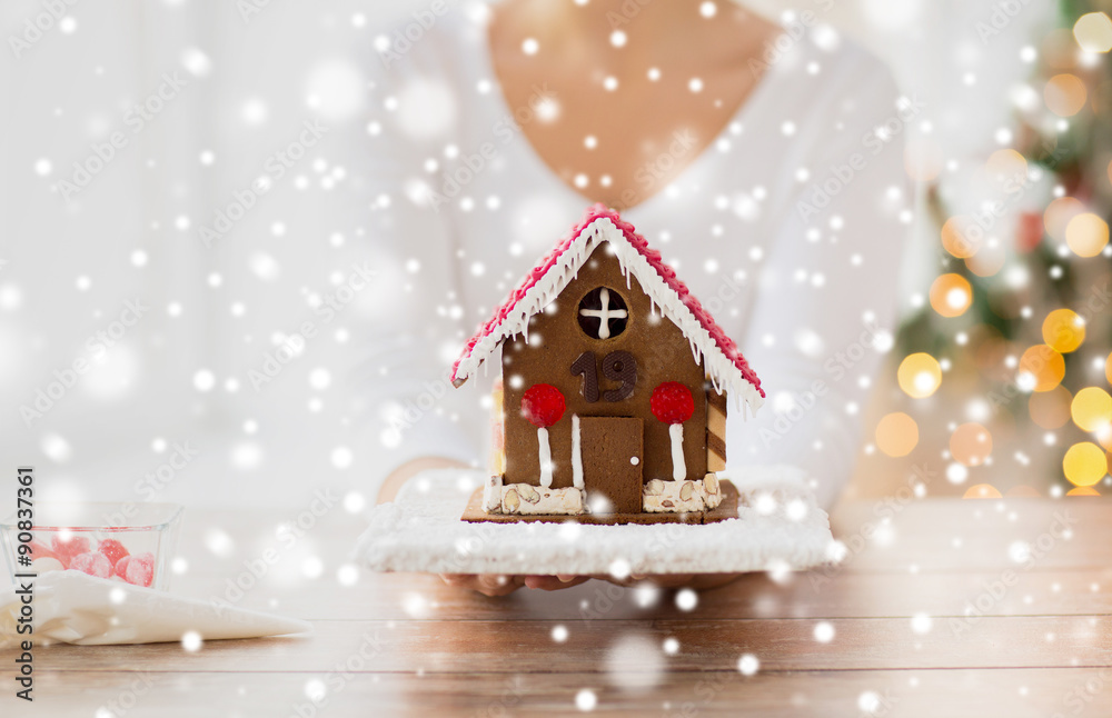 close up of woman showing gingerbread house