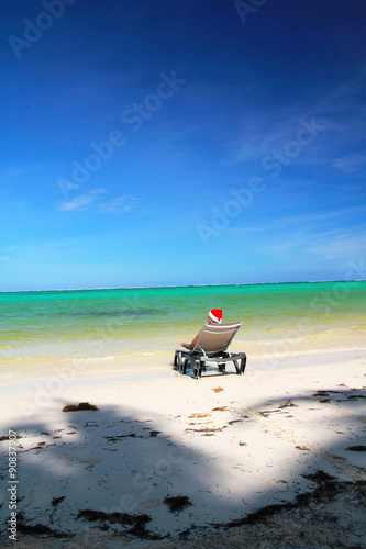Man in Santa hat resting on chaise longue