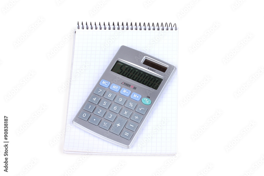 Calculator and notebook with blue pen on white Calculator and notebook with blue pen on white