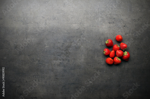 Strawberries on grey kitchen table with copyspace