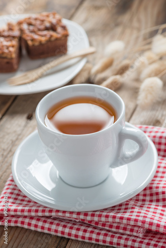 A cup of tea with toffee cake.