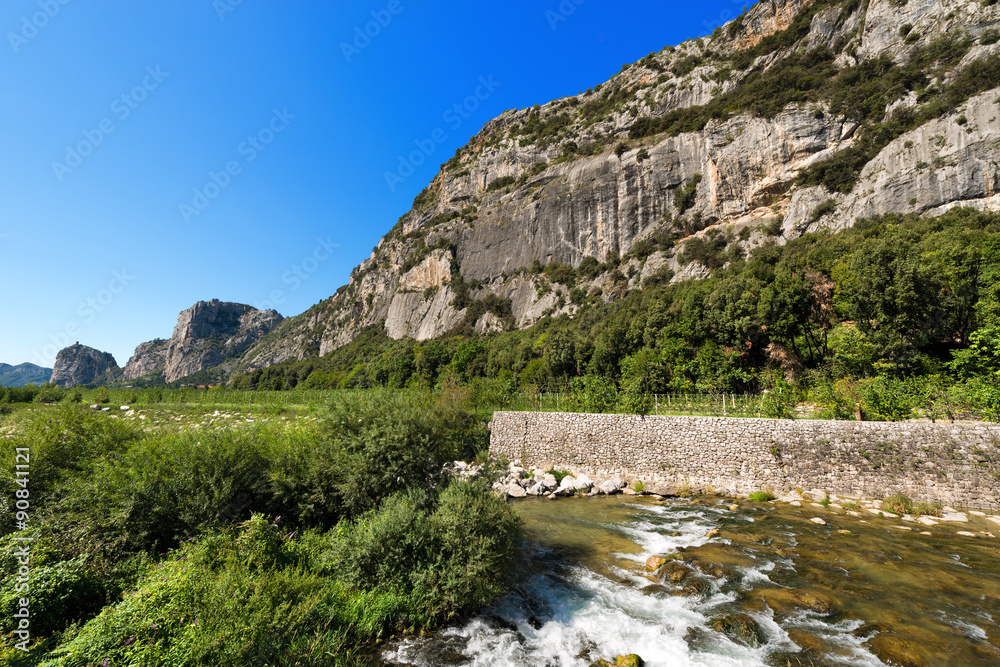 Cliffs of Arco - Trentino Italy / Rock walls with castle in Arco of Trento and Sarca river near the Garda Lake in Trentino Alto Adige, Italy, Europe