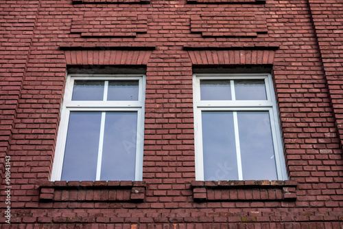 Windows in a red wall