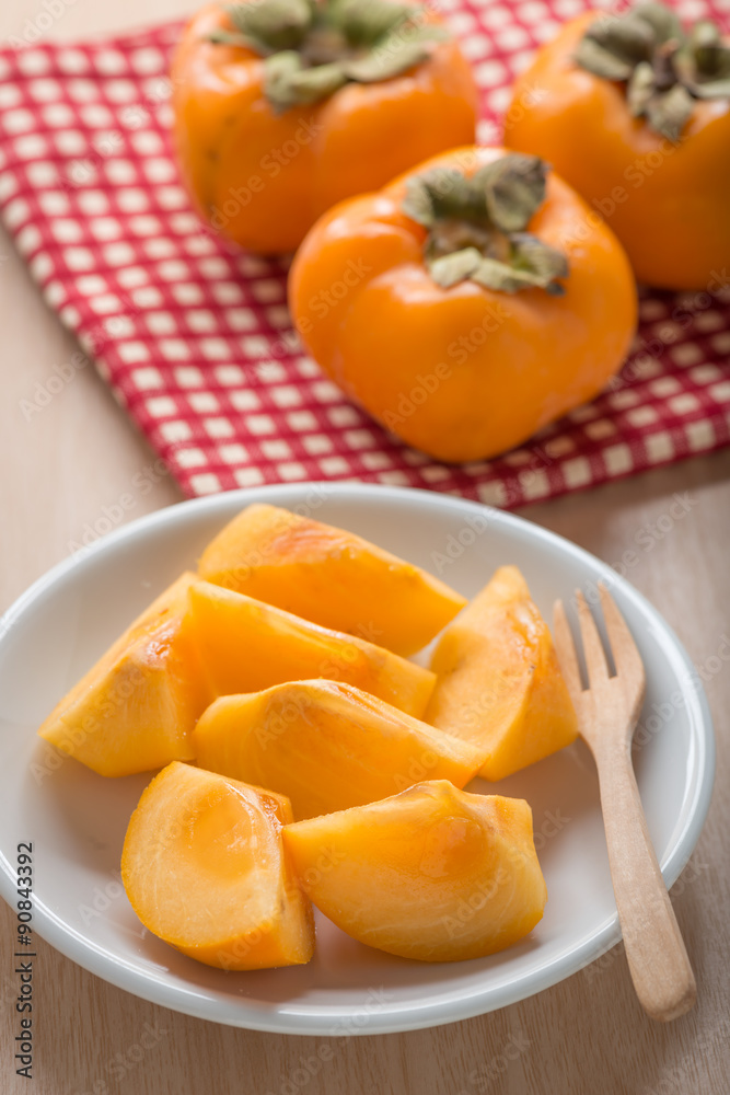 Fresh Persimmon fruit in white dish. Fresh Persimmon fruit in white dish.
