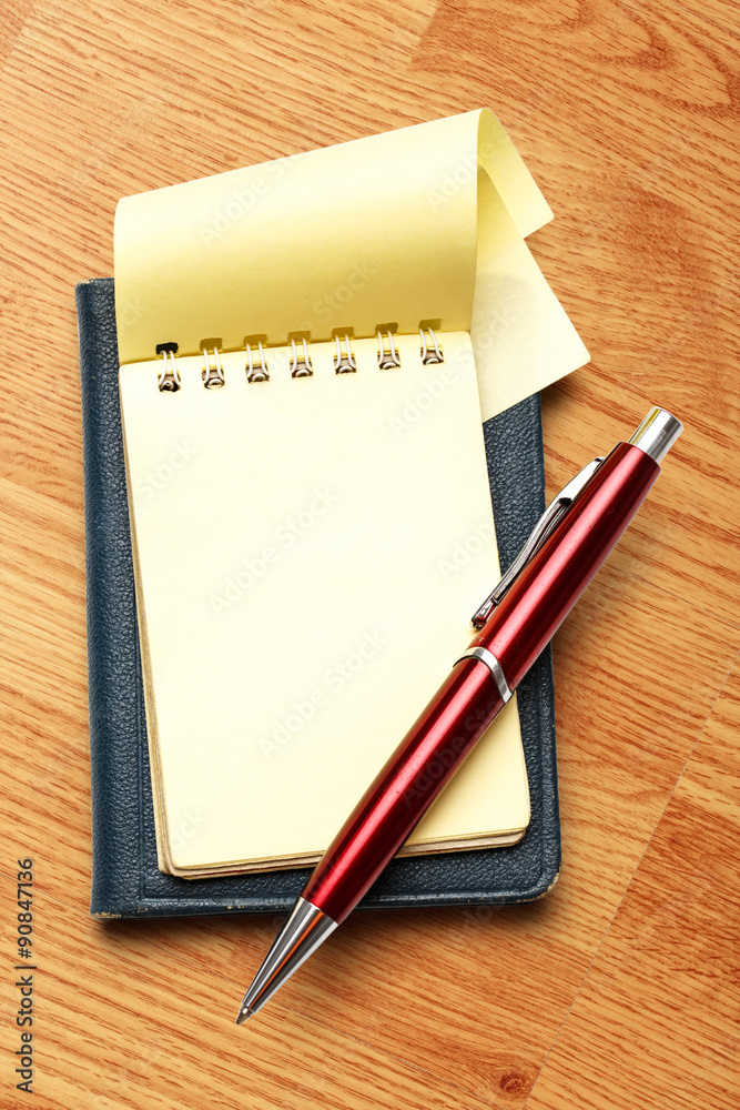Yellow blank notepad with pen Yellow blank notepad with pen